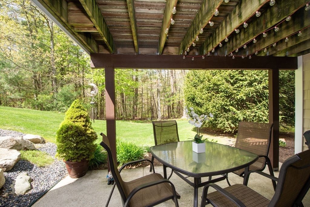 53 Hemlock Circle, Unit 53 Hanover, MA 02339 - Photo 21 of 27 a backyard of a house with table and chairs