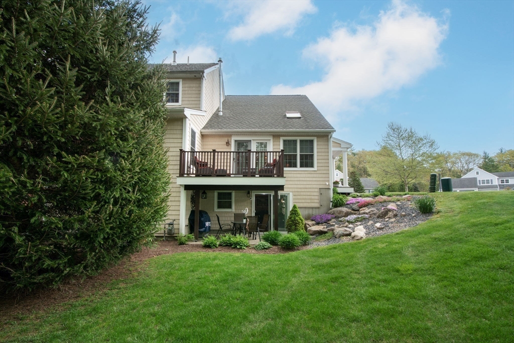 53 Hemlock Circle, Unit 53 Hanover, MA 02339 - Photo 22 of 27 a front view of a house with a garden and plants
