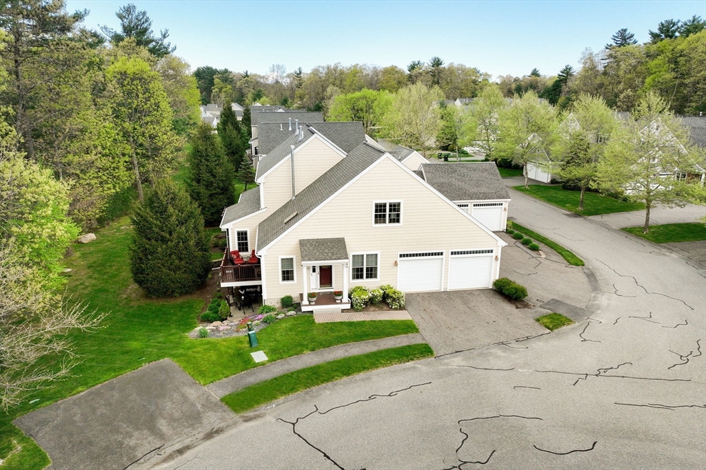 53 Hemlock Circle, Unit 53 Hanover, MA 02339 - Photo 23 of 27 a view of a white house with a yard garden and plants