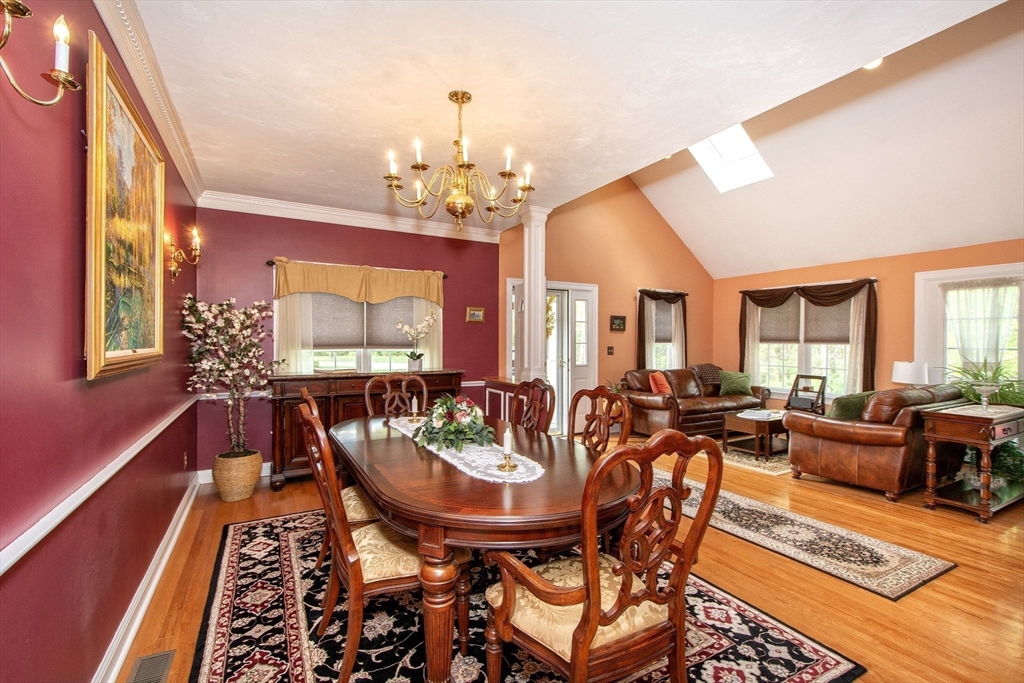 53 Hemlock Circle, Unit 53 Hanover, MA 02339 - Photo 4 of 27 a view of a dining room with furniture a chandelier and wooden floor