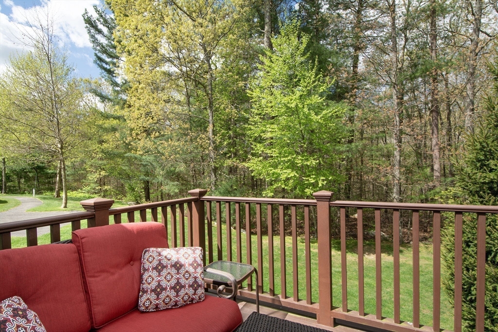 53 Hemlock Circle, Unit 53 Hanover, MA 02339 - Photo 8 of 27 a roof deck with couches and wooden fence