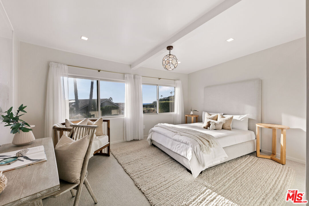 31558 Victoria Point Road Malibu, CA 90265 - Photo 46 of 55 a bedroom with a large bed and windows