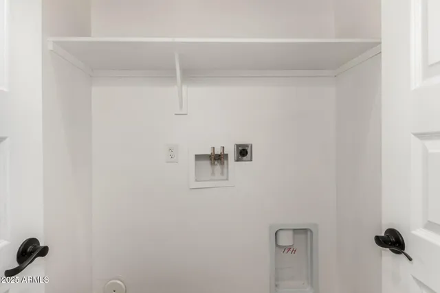 a living room with a large window and furniture