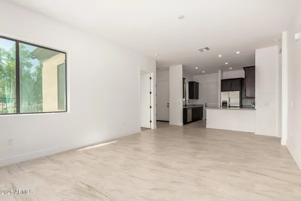 a view of a kitchen with kitchen island and stainless steel appliances