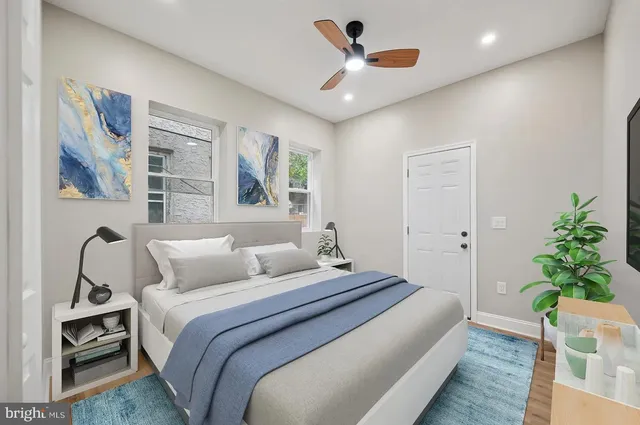 a bedroom with a large bed and a chandelier