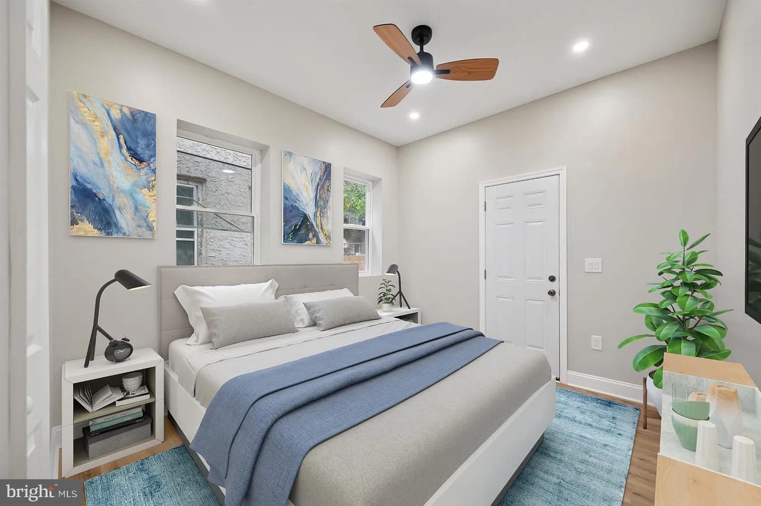 a bedroom with a large bed and a chandelier