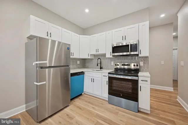 a kitchen with stainless steel appliances a refrigerator stove and microwave