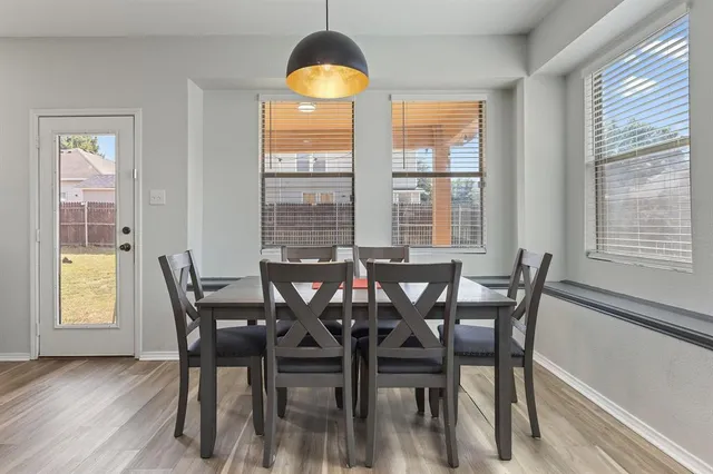 a view of a dining room with furniture and window