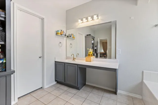 a spacious bathroom with a double vanity sink and mirror