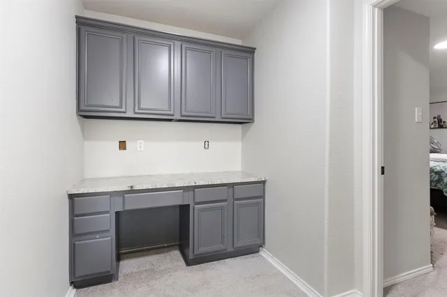 a room with granite countertop cabinets and sink