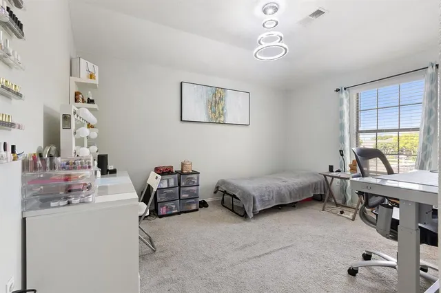 a bedroom with furniture and a window