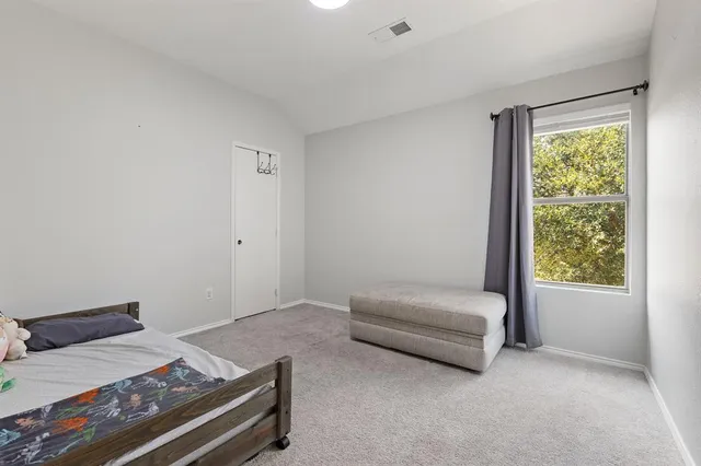 a bedroom with a bed and a window