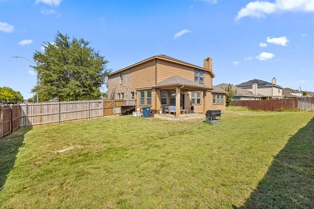 a view of a house with a backyard and a garden