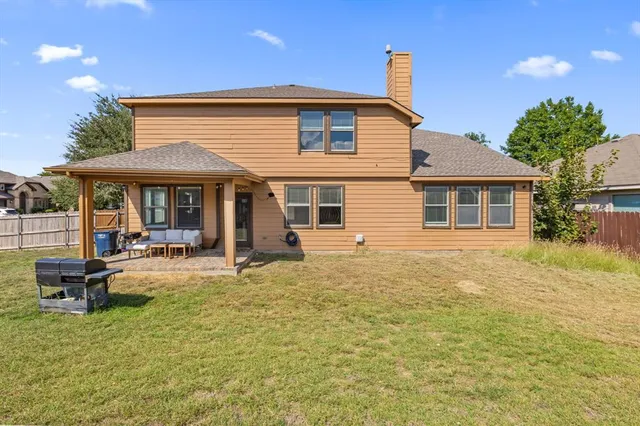 a view of a house with a backyard and sitting area