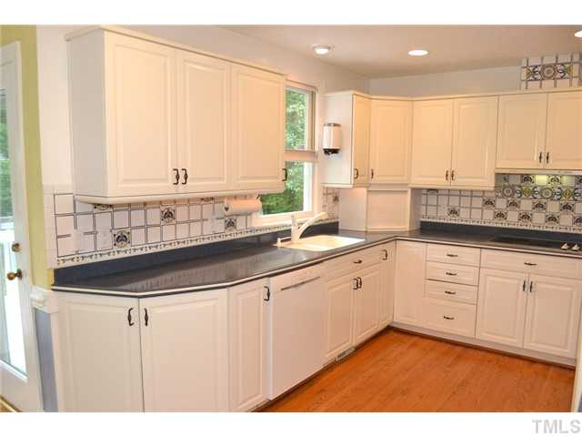 901 Streamer Court Raleigh, NC 27614 - Photo 4 of 21 Bright kitchen with hardwood floor, recessed lighting, lots of cabinet space, and tile backsplash
