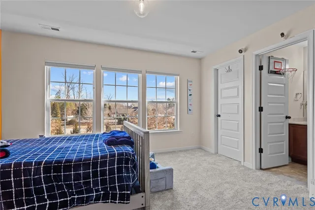 a living room with a bed and a window