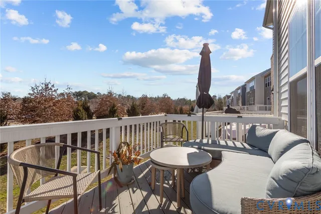 a balcony with table and chairs