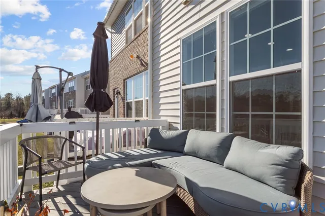 a balcony with furniture and a window