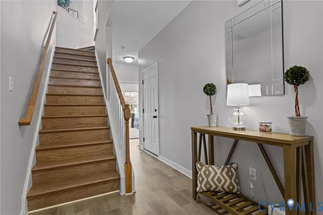 a view of entryway and hall with wooden floor