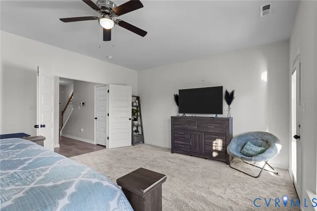 a bedroom with furniture and a flat screen tv