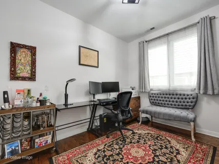 a view of a livingroom with workspace and a window