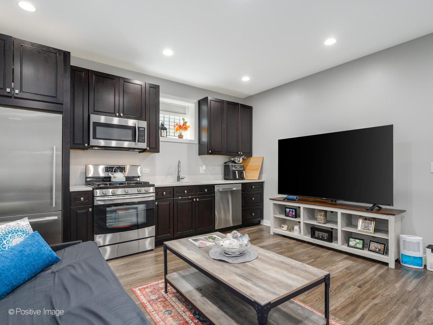 2139 North Bingham Street Chicago, IL 60647 - Photo 20 of 24 a living room with stainless steel appliances furniture a flat screen tv and kitchen view