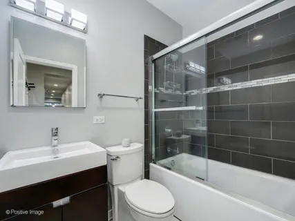 a bathroom with a sink mirror toilet and bathtub