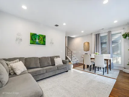 a living room with furniture a rug and a flat screen tv