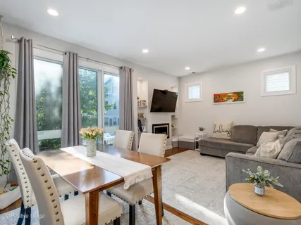 a living room with furniture flat screen tv and a large window