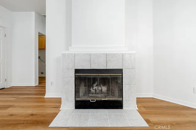 a living room with a fireplace and a stove with wooden floor