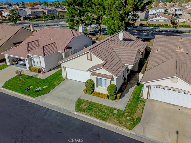 an aerial view of multiple houses with a yard