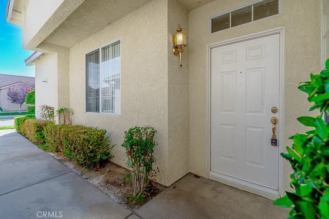 front view of a house with potted plants