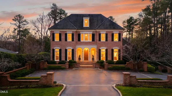 a front view of a house with yard and green space
