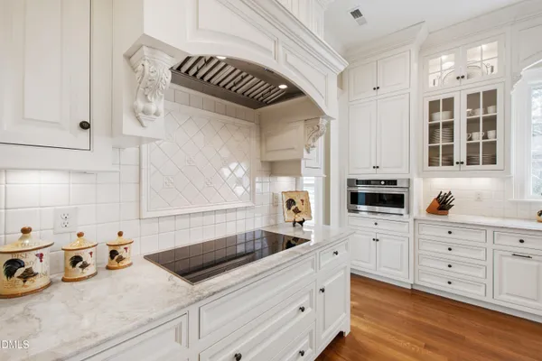 a living room with furniture a chandelier and a dining table