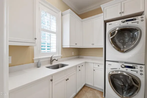 a spacious bathroom with a double vanity sink a large mirror and shower