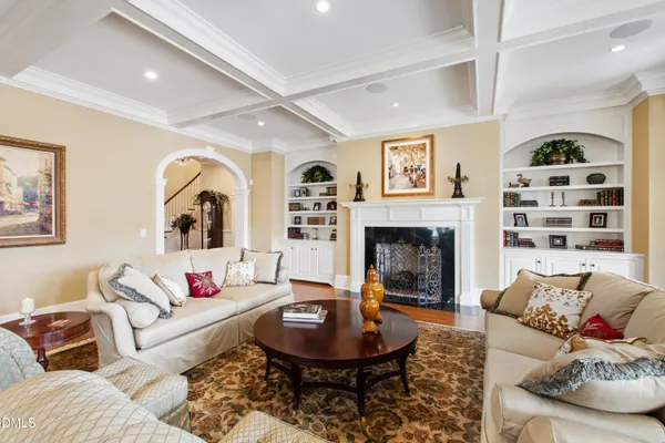 a view of a kitchen with kitchen island wooden floors granite counter tops and white appliances