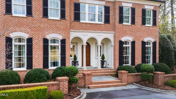 a view of a brick house with potted plants