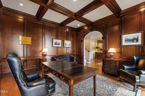 a large kitchen with stainless steel appliances a large center island attached withe living room