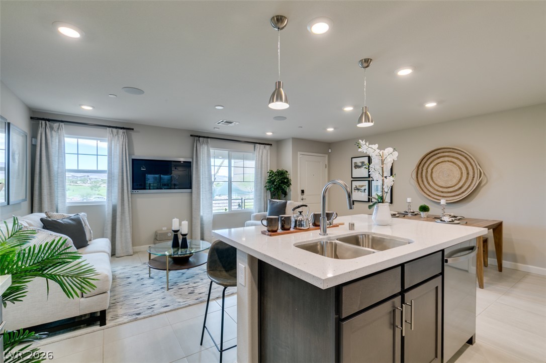 653 Pickled Pepper Place Henderson, NV 89011 - Photo 18 of 35 An open-concept living area with a contemporary kitchen island and recessed lighting.