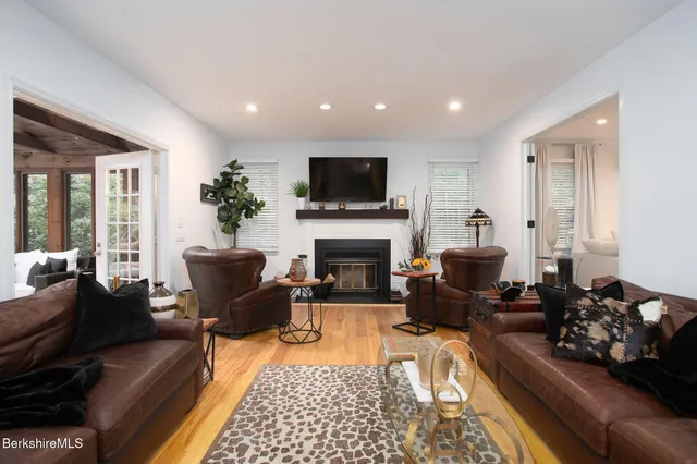 a kitchen with stainless steel appliances kitchen island granite countertop a table chairs sink and cabinets