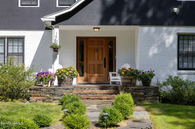 a front view of a house with flowers