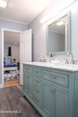a spacious bedroom with a bed and a potted plant