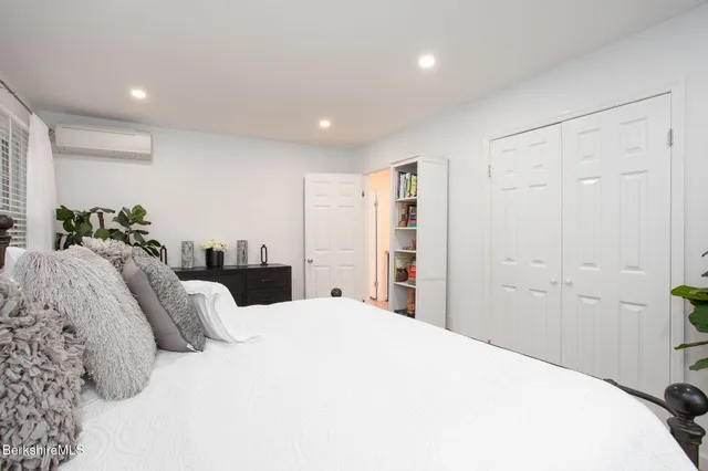 a bathroom with a granite countertop sink mirror and a bathtub