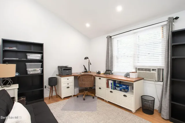 a living room with furniture fireplace and a large window
