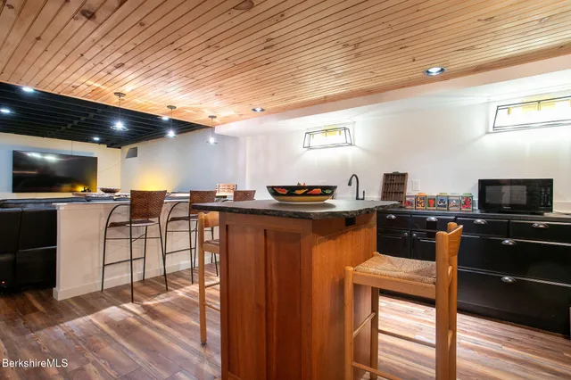 a front view of a house with a yard garage and outdoor seating