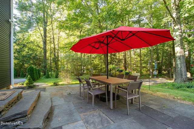 a view of a chairs and table in backyard