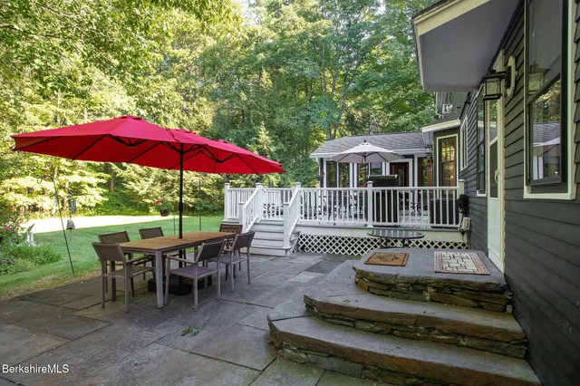 a view of a house with backyard sitting area and garden