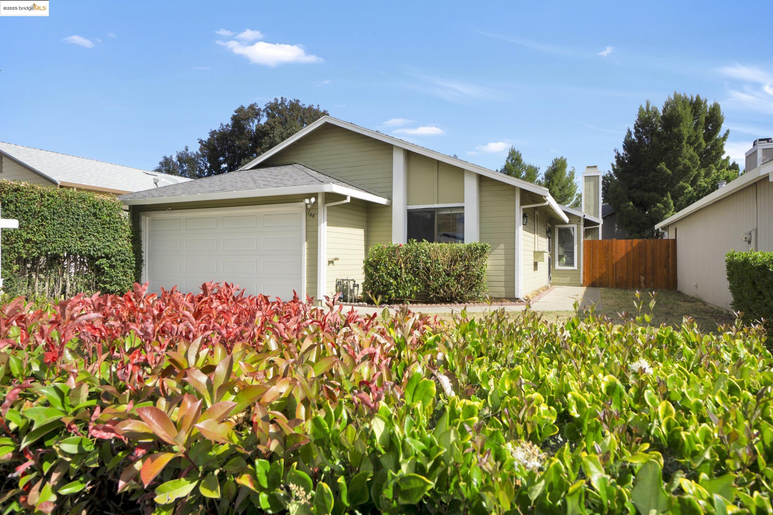 a front view of house with yard and trees around