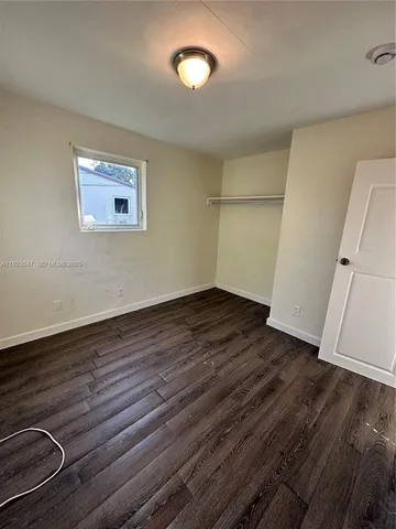 an empty room with wooden floor