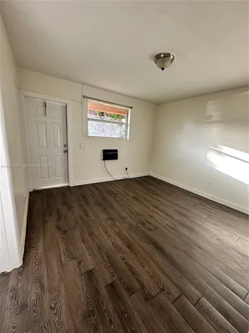 a view of a room with wooden floor
